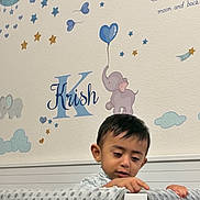 Krish joined the competition — help win amazing prizes! baby_room, balloon, blanket, boy, child, clouds, curious, earring, elephant, face, furniture, head, indoor, name, nursery, painting, soft_texture, stars, toddler, wall_decoration