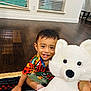 Krish joined the competition — help win amazing prizes! child, colorful_shirt, cute, earrings, hand, happy, home, indoor, large_toy, person, playful, rug, short_hair, sitting, smiling, stuffed_animal, toddler, toy, window_blinds, wooden_floor