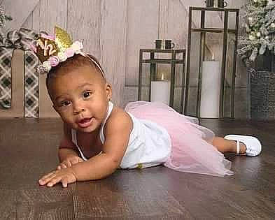 Skyler is registered to the contest to win money with this photo: baby, baby_toddler_clothing, child, crawling, event, fashion_accessory, flash_photography, flooring, fun, hair_accessory, happy, hardwood, headband, headpiece, iris, person, plant, smile, toddler, wood