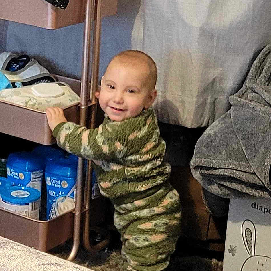 Bryce joined the competition — help win amazing prizes! baby, bed, bedroom, blanket, clothing, crawling, face, footwear, furniture, head, indoors, military, militaryuniform, newborn, pants, person, photography, portrait, room, sitting