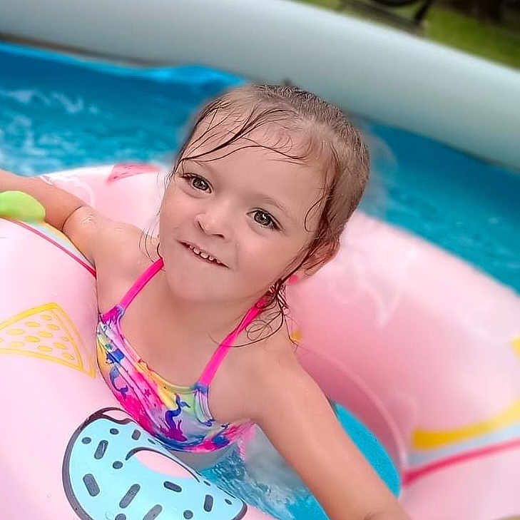 Jacelyn is registered to the contest to win money with this photo: baby, bathing, clothing, face, hair, happy, head, leisureactivities, person, photography, pool, portrait, smile, sport, summer, swimming, swimmingpool, swimwear, water, watersports