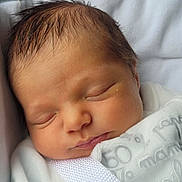 Gabriel participe au concours pour gagner de l'argent avec cette photo : baby, newborn, infant, sleeping, swaddle, blanket, face, closed_eyes, cheeks, hair, skin, peaceful, portrait, head, resting, cozy, nursery, fabric, pillow, closeup