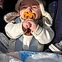 baby, pacifier, hooded_sweater, car_seat, blanket, bottle, infant, clothing, hand, face, child, seatbelt, soft_toy, warm, cute, newborn, portrait, indoors, comfort, baby_care