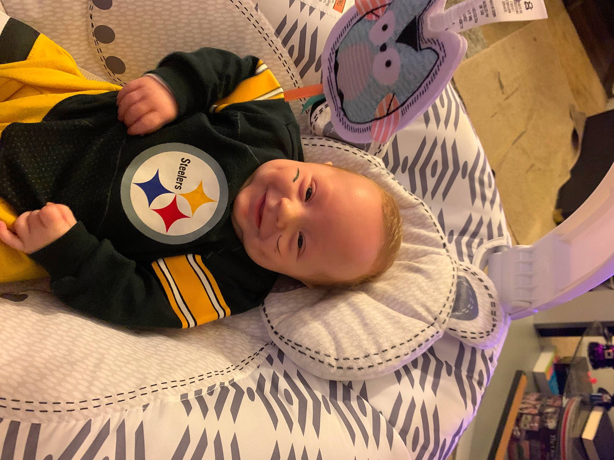 Dustin is registered to the contest to win money with this photo: art, baby, baby_products, baby_toddler_clothing, carmine, cheek, child, comfort, eyelash, flooring, fun, happy, linens, pattern, person, room, smile, t_shirt, toddler, visual_arts