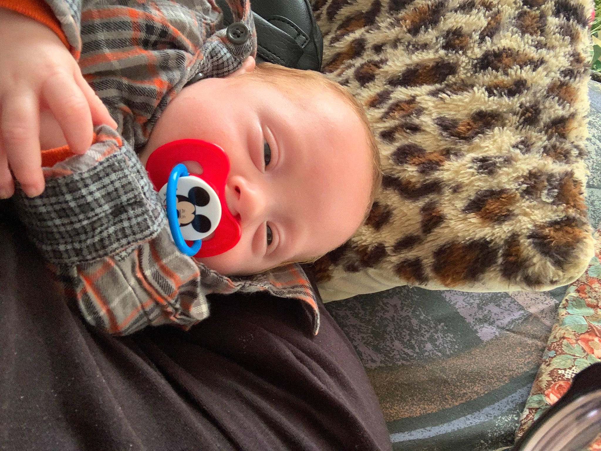 Dustin is registered to the contest to win money with this photo: baby, baby_toddler_clothing, cheek, child, collar, comfort, fun, fur, linens, military_camouflage, pattern, person, plaid, room, sitting, sleeve, tartan, textile, toddler