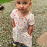 Charlee is registered to the contest to win money with this photo: child, toddler, dress, rainbow_pattern, outdoor, gravel, shoes, blue_eyes, short_sleeves, pockets, curious, standing, person, nature, grass, casual, portrait, daylight, cute, innocence