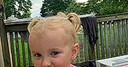 Charlee joined the competition — help win amazing prizes! child, toddler, blonde_hair, pigtails, pink_shirt, blue_eyes, outdoor, deck, wooden_fence, trees, sky, cloudy, playful, tongue_out, person, hand, clothing, nature, summer, cute