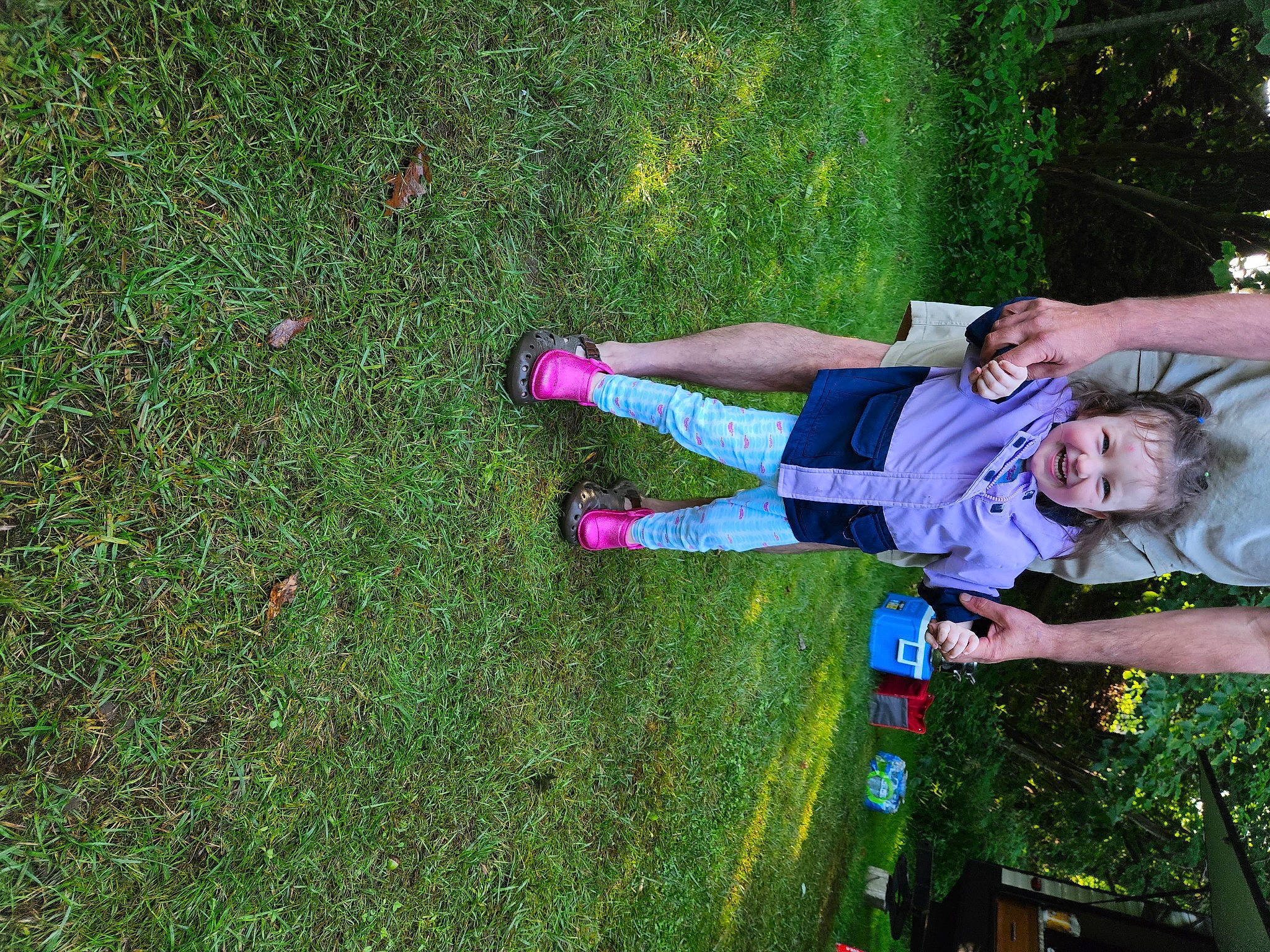 Lilly is registered to the contest to win money with this photo: arm, child, foot, fun, grass, grass_family, green, happy, human_leg, joy, knee, lawn, leisure, magenta, people_in_nature, person, plant, recreation, shorts, shrub
