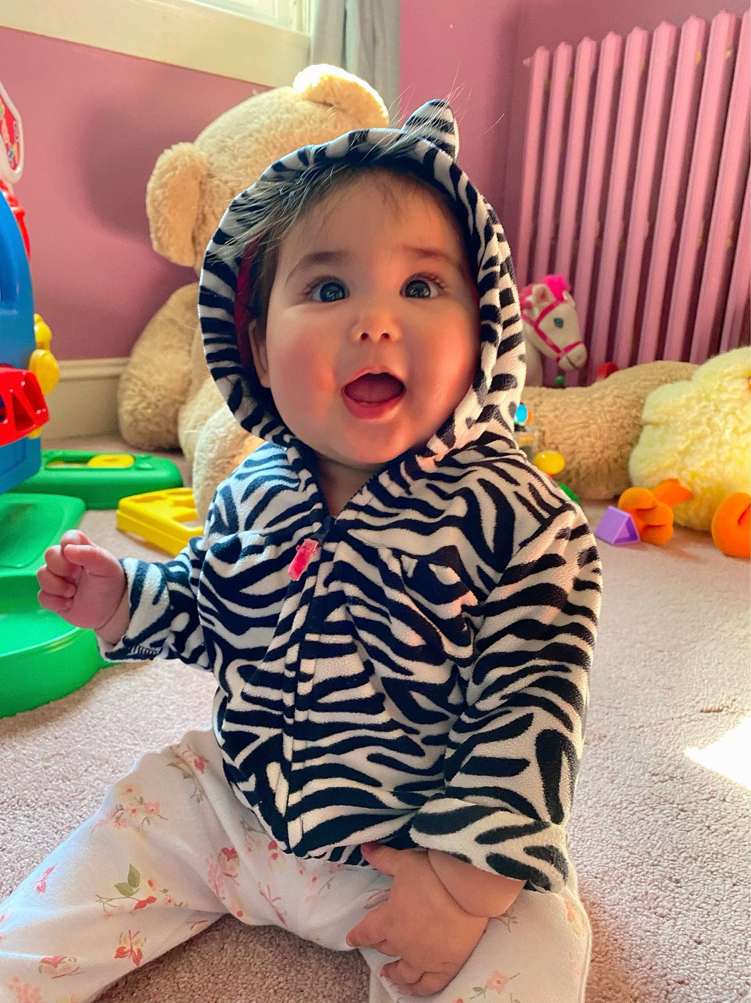 Amara Faith is registered to the contest to win money with this photo: baby, baby_playing_with_toys, baby_toddler_clothing, child, comfort, facial_expression, flooring, fun, happy, human_body, human_leg, leisure, person, sitting, skin, sleeve, smile, snapshot, surprise, thigh