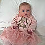 Kendal is registered to the contest to win money with this photo: baby, infant, pink_dress, bunny_design, white_bed, pillow, blanket, cute, portrait, child, indoors, soft_lighting, knitwear, tutu, curious, sitting, face, person, young_child, home