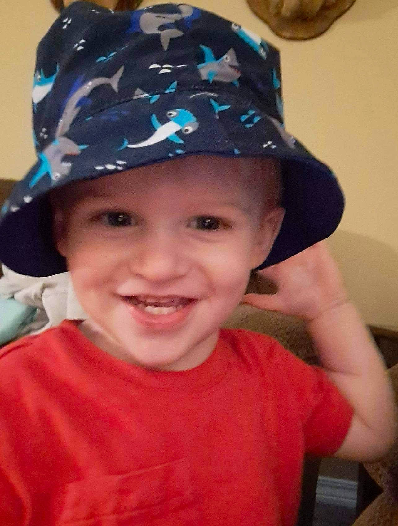 Hunter is registered to the contest to win money with this photo: baseball_cap, cap, child, chin, cool, costume_hat, electric_blue, face, facial_expression, fashion_accessory, fun, happy, hat, headgear, headwear, helmet, joy, person, personal_protective_equipment, smile