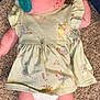 Janet is registered to the contest to win money with this photo: baby, infant, pacifier, carpet, dress, winnie_the_pooh, clothing, diaper, legs, feet, skin, cute, lying_down, child, person, indoors, floor, fabric, pattern, toddler