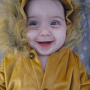 Kefira is registered to the contest to win money with this photo: baby, child, smiling, face, hood, costume, lion_costume, fur, yellow_clothing, cute, happy, portrait, infant, buttoned_jacket, indoors, closeup, wide_eyes, playing, young_child, adorable