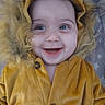 baby, child, smiling, face, hood, costume, lion_costume, fur, yellow_clothing, cute, happy, portrait, infant, buttoned_jacket, indoors, closeup, wide_eyes, playing, young_child, adorable