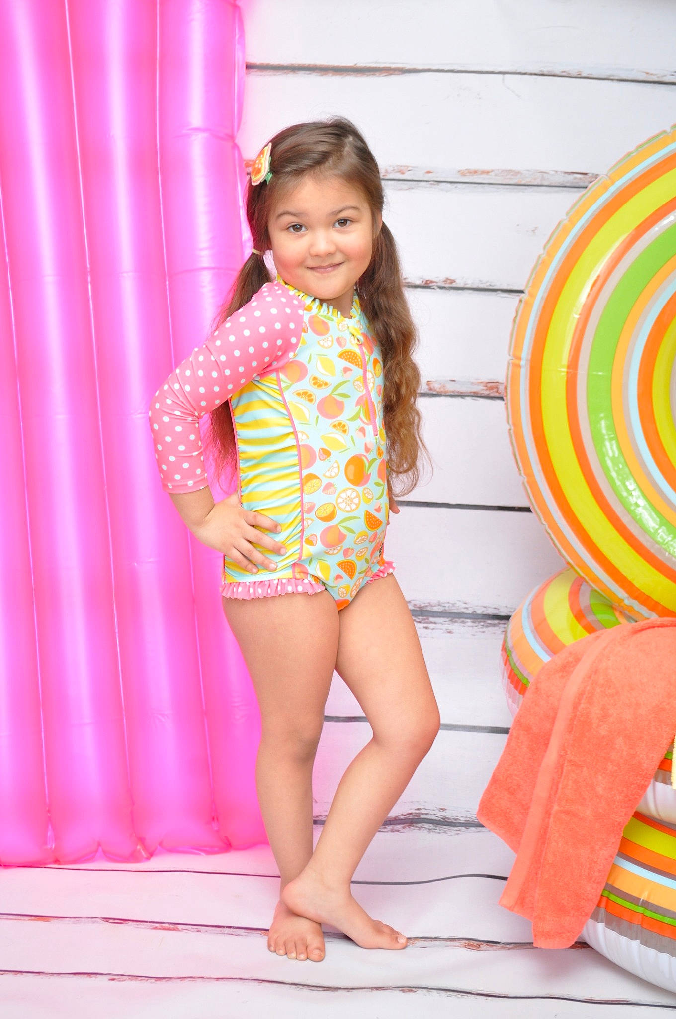 Aryana joined the competition — help win amazing prizes! barefoot, child, child_model, clothing, finger, joy, leg, long_hair, orange, pattern, person, pink, play, swimwear, textile, thigh, toddler