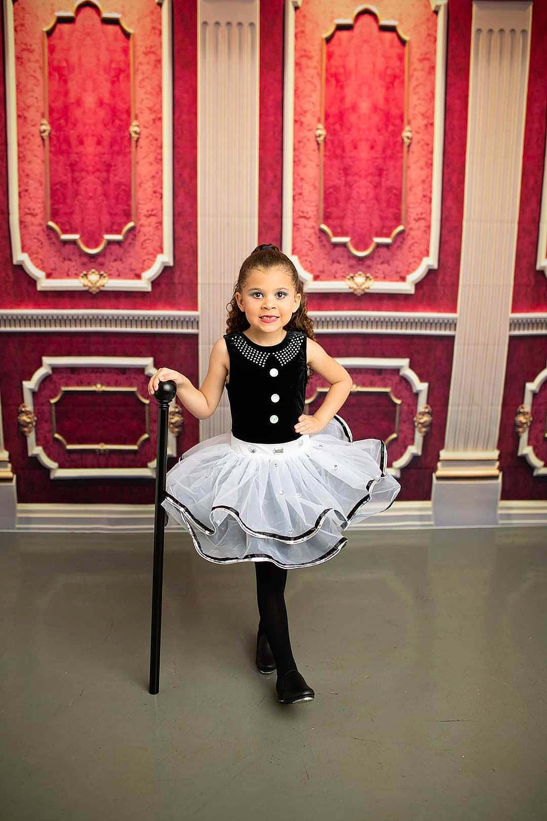 Alyza is registered to the contest to win money with this photo: child, door, dress, entertainment, event, fashion_design, flash_photography, formal_wear, fun, happy, human_leg, joy, knee, magenta, person, pink, room, sandal, shoulder, standing