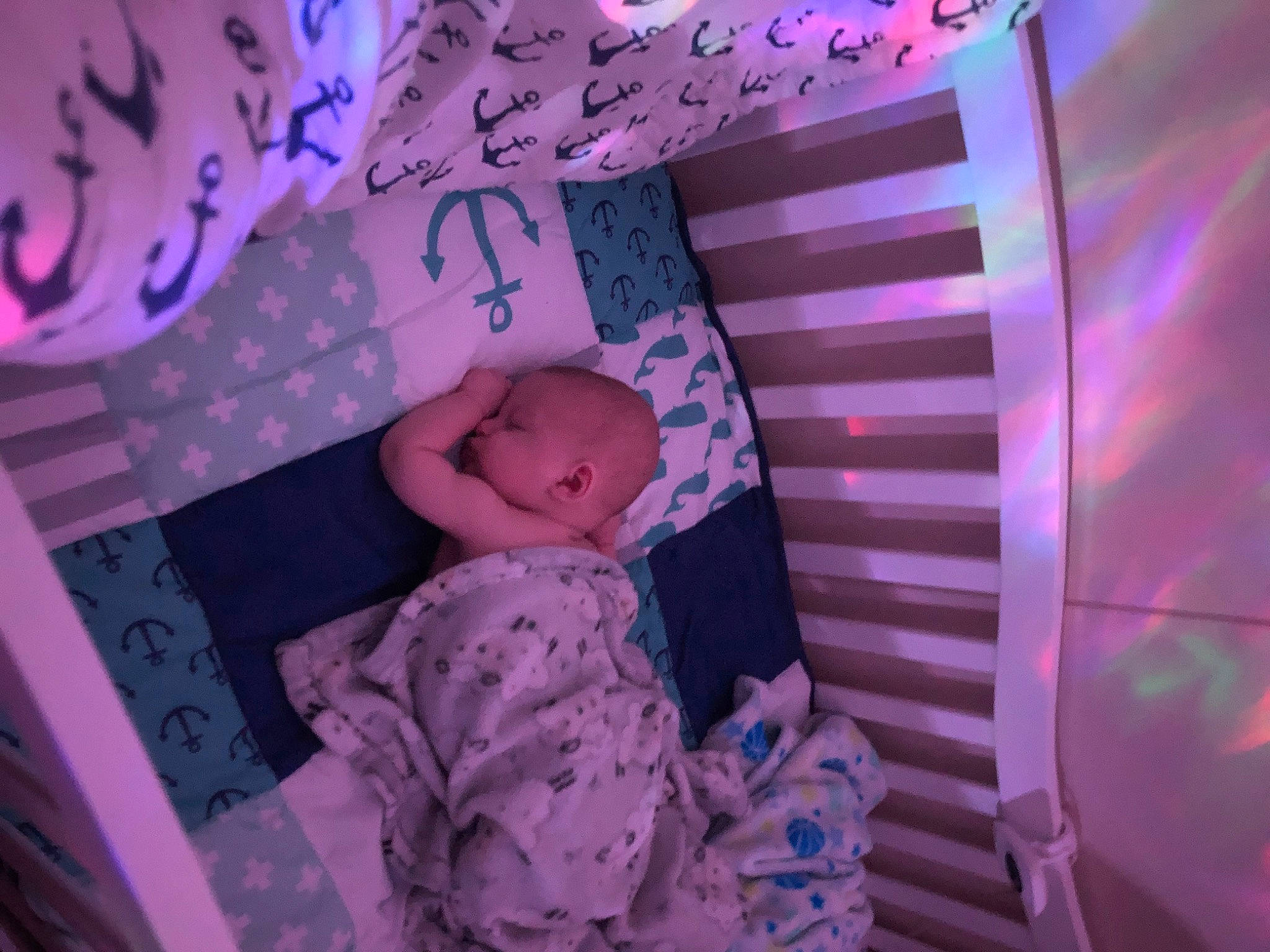 Justice is registered to the contest to win money with this photo: baby, baby_products, baby_toddler_clothing, bed, bedtime, child, comfort, flash_photography, linens, magenta, pattern, person, petal, pink, purple, room, sitting, skin, textile, toddler