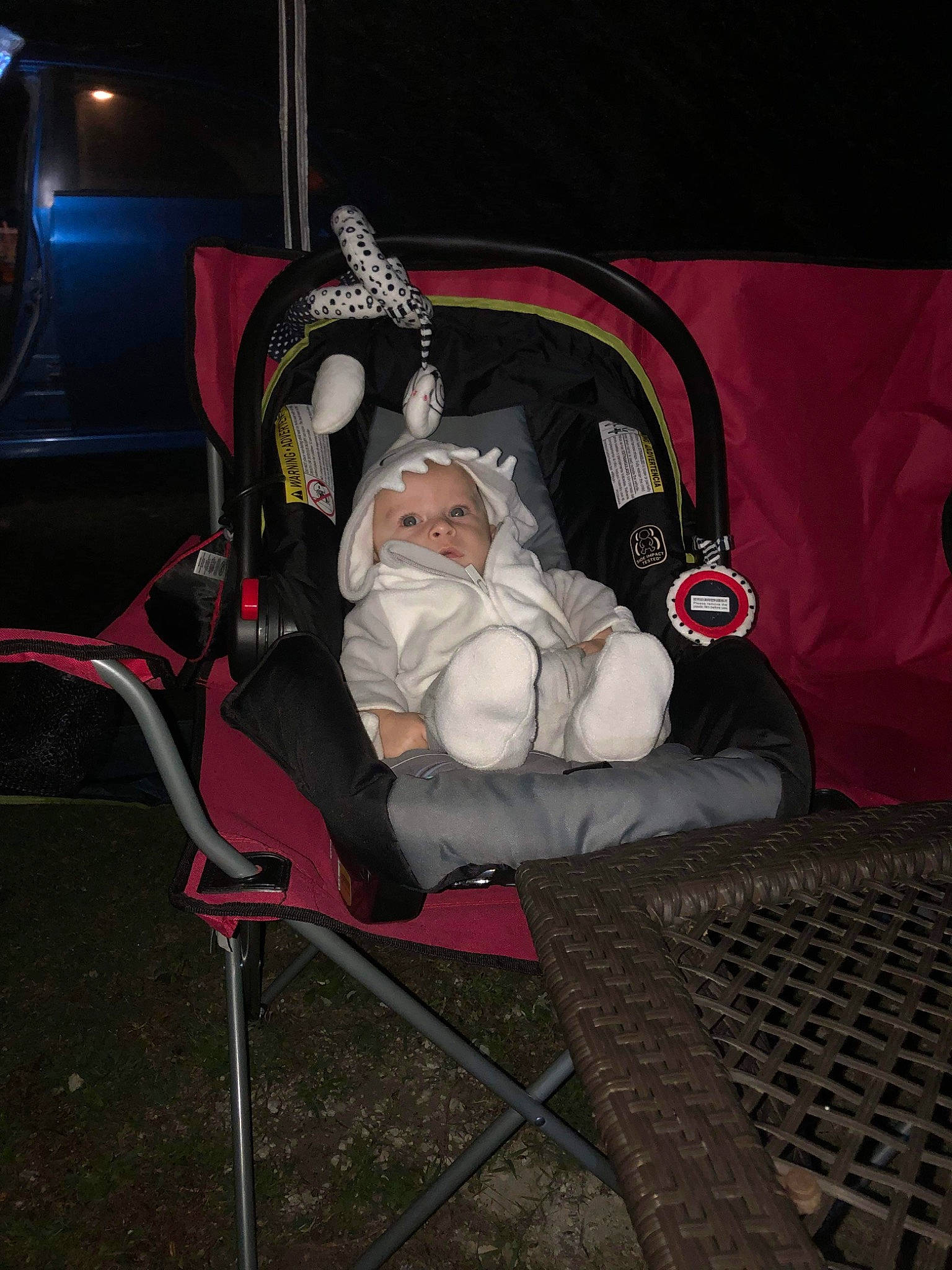 Justice is registered to the contest to win money with this photo: auto_part, baby, baby_carriage, baby_products, baby_safety, car_seat, carmine, chair, child, comfort, darkness, fun, grass, lap, motor_vehicle, person, room, sitting, toddler