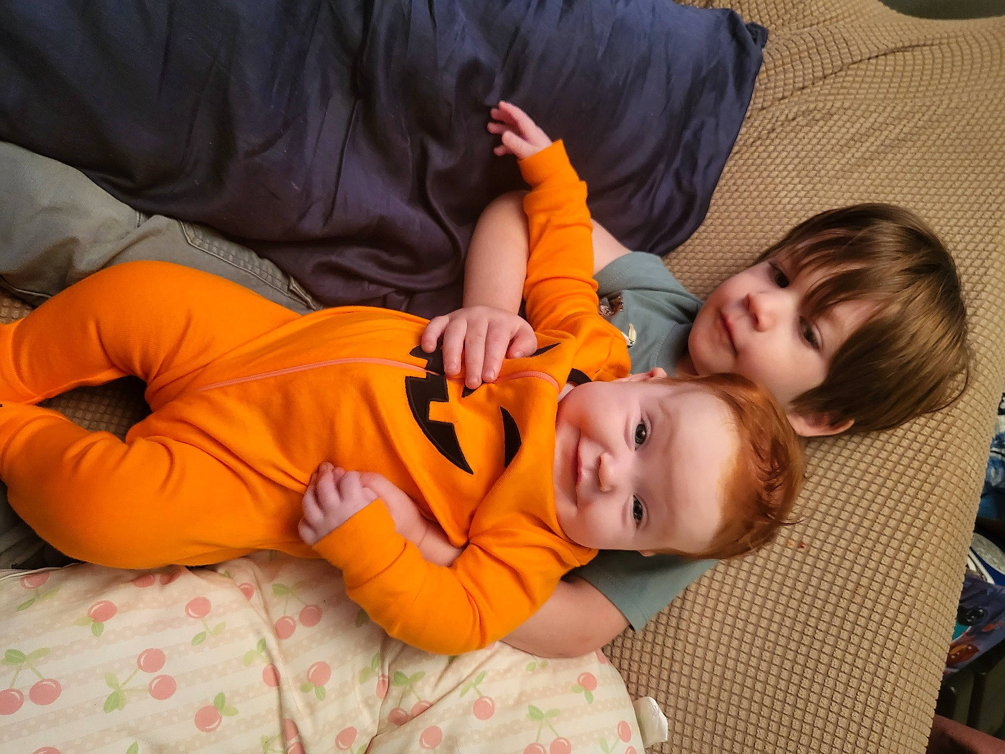 Payton is registered to the contest to win money with this photo: baby, bean_bag, bean_bag_chair, calabaza, child, comfort, couch, flooring, fun, gourd, happy, human_leg, leisure, orange, person, pumpkin, room, sitting, toddler, winter_squash