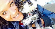 Major is registered to the contest to win money with this photo: black_and_white_dog, brick_wall, close_up, collar, curly_hair, dog, dog_tag, eyes, fur, hand, happy, leather_jacket, outdoor, person, pet, porch, selfie, small_dog, smile, sunlight