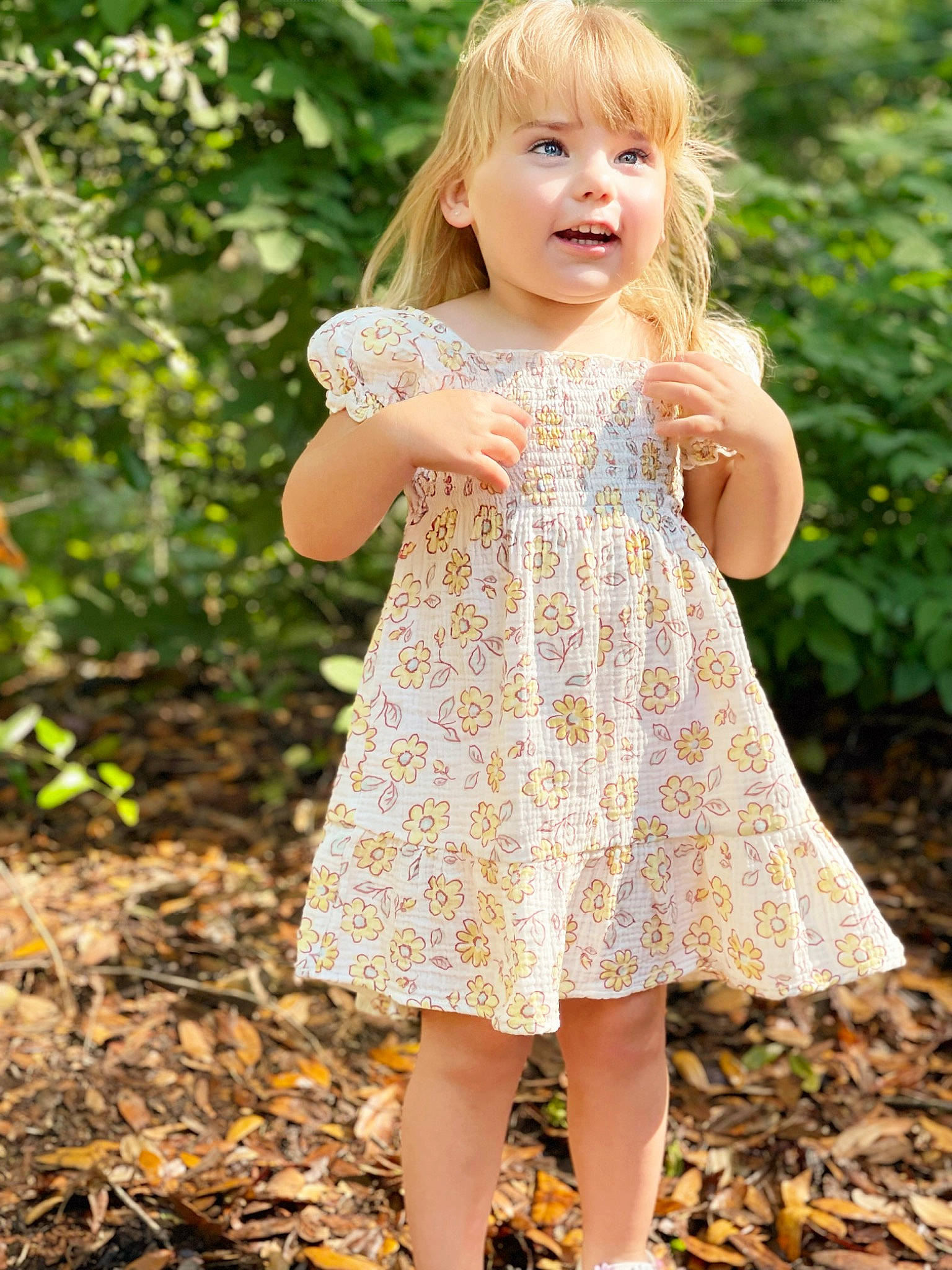 Brea is registered to the contest to win money with this photo: baby_toddler_clothing, clothing, day_dress, dress, fawn, finger, grass, happy, one_piece_garment, pattern, people_in_nature, person, pink, plant, shoulder, skin, sleeve, smile, summer, toddler