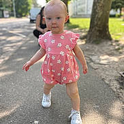 Lyah a rejoint le concours — aidez-le/la à gagner de superbes lots ! blurred_background, casual, child, cute, daylight, greenery, nature, outdoor, person, pink_clothing, romper, shadows, sidewalk, summer, sunlight, toddler, tree, walking, white_shoes, young_child