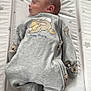newborn, baby, sleeping, onesie, bunny_print, crib, star_pattern, padded_crib, infant, cozy, cute, sleep, child, soft_lighting, peaceful, resting, indoors, clothing, portrait, babywear