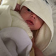 Jaxxon-Brian joined the competition — help win amazing prizes! baby, blanket, child, comfort, cozy, cute, expression, face, hand, hooded_towel, indoors, infant, lying_down, newborn, skin, small_hand, soft_texture, towel, warm, wrapped