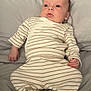 baby, bed, blanket, comfort, curious, cute, face, hands, head, indoors, infant, lying_down, newborn, pajamas, person, portrait, skin, sleepwear, soft_fabric, striped_clothing