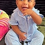 Xyyla is registered to the contest to win money with this photo: baby, child, pajamas, blue_clothing, socks, smiling, happy, indoor, carpet, toy, colorful, cute, infant, person, face, hand, sitting, playful, young_child, portrait