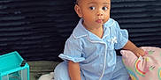 Xyyla joined the competition — help win amazing prizes! toddler, child, pajamas, blue_clothing, blanket, toy, carpet, indoor, cute, sitting, face, person, home, soft_texture, curious, earrings, pink_blanket, colorful, expression, young_child