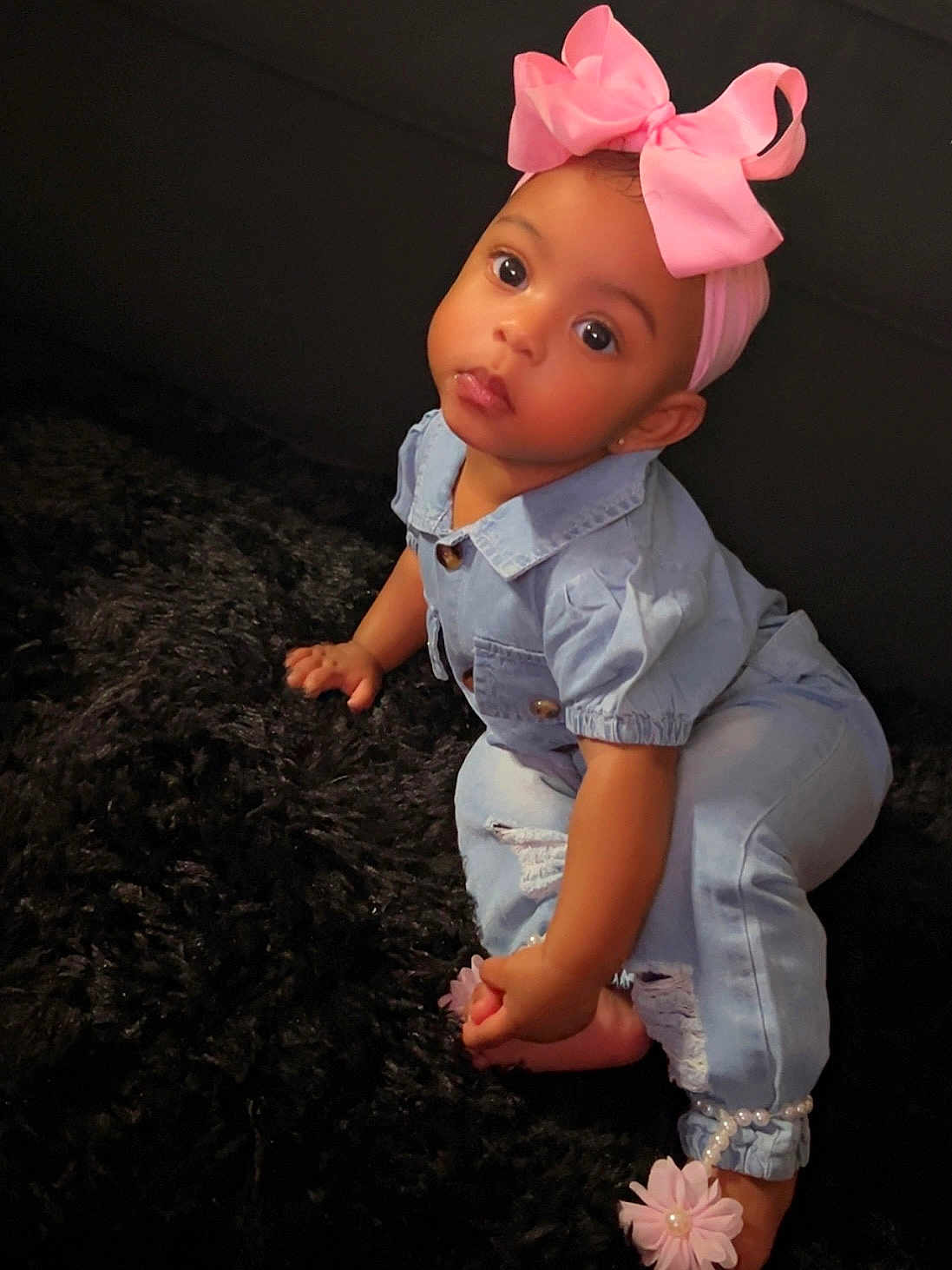 Xyyla is registered to the contest to win money with this photo: baby, child, pink_bow, denim, jeans, sitting, carpet, black, cute, portrait, indoor, footwear, flower_accessory, pearl_bracelet, curious, little_girl, fashion, candid, adorable, toddler