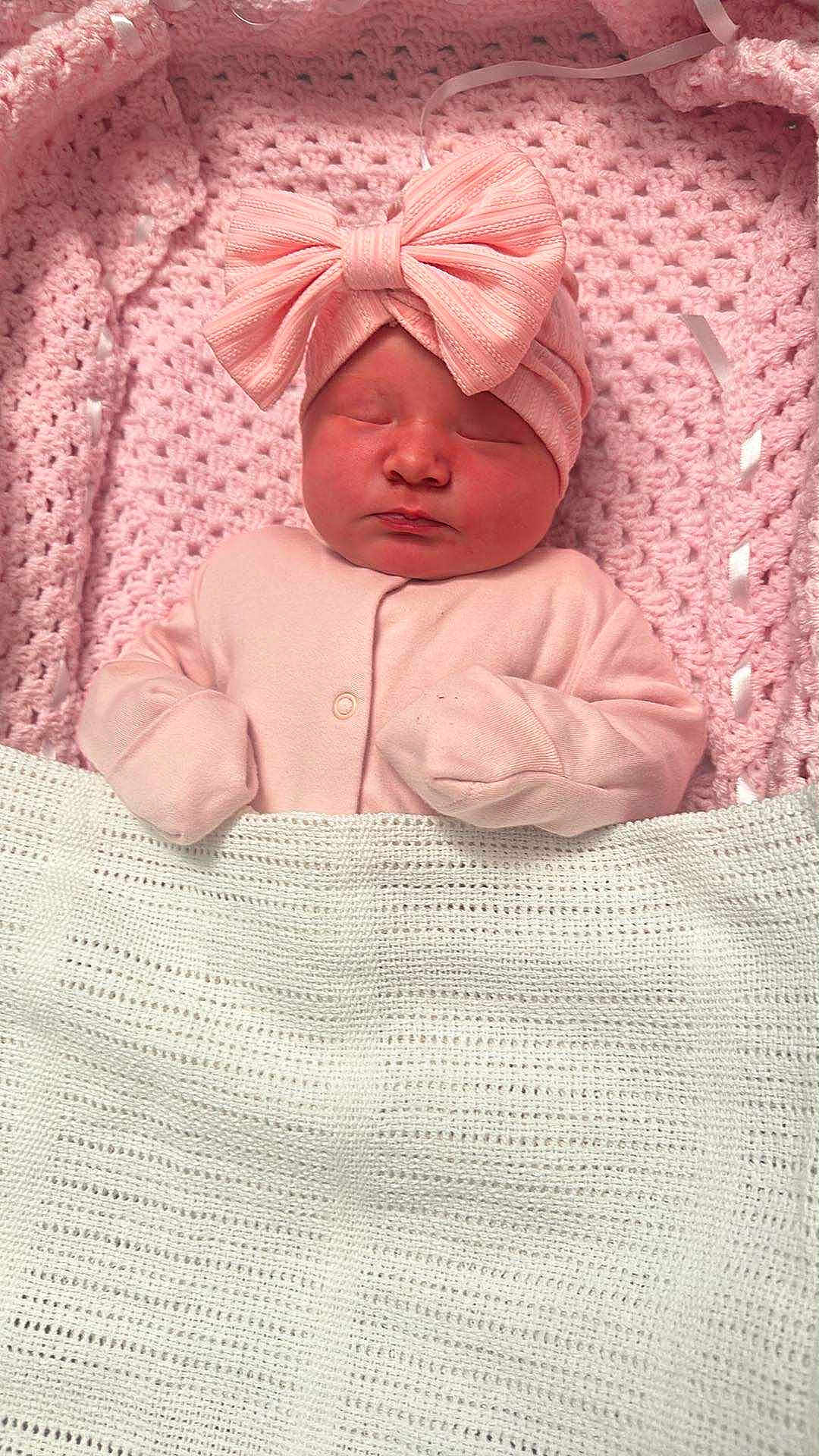 Amelia is registered to the contest to win money with this photo: baby, newborn, sleeping, pink, blanket, hat, bow, cozy, cute, infant, wrapped, soft, child, portrait, clothing, knit, peaceful, indoors, resting, headwear