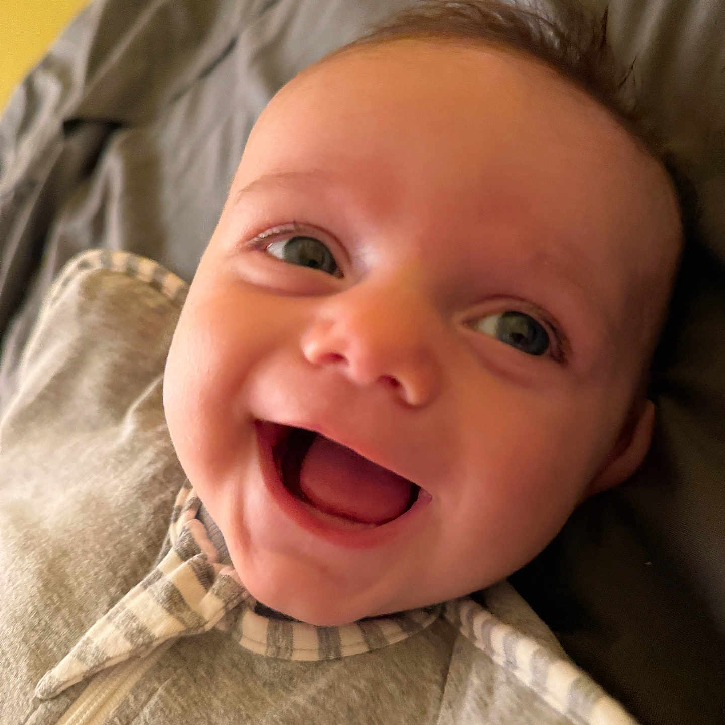Lucas joined the competition — help win amazing prizes! baby, child, close_up, clothing, cozy, cute, expression, eyes, face, grey, happy, indoors, infant, lying_down, mouth_open, portrait, smiling, soft, striped, young