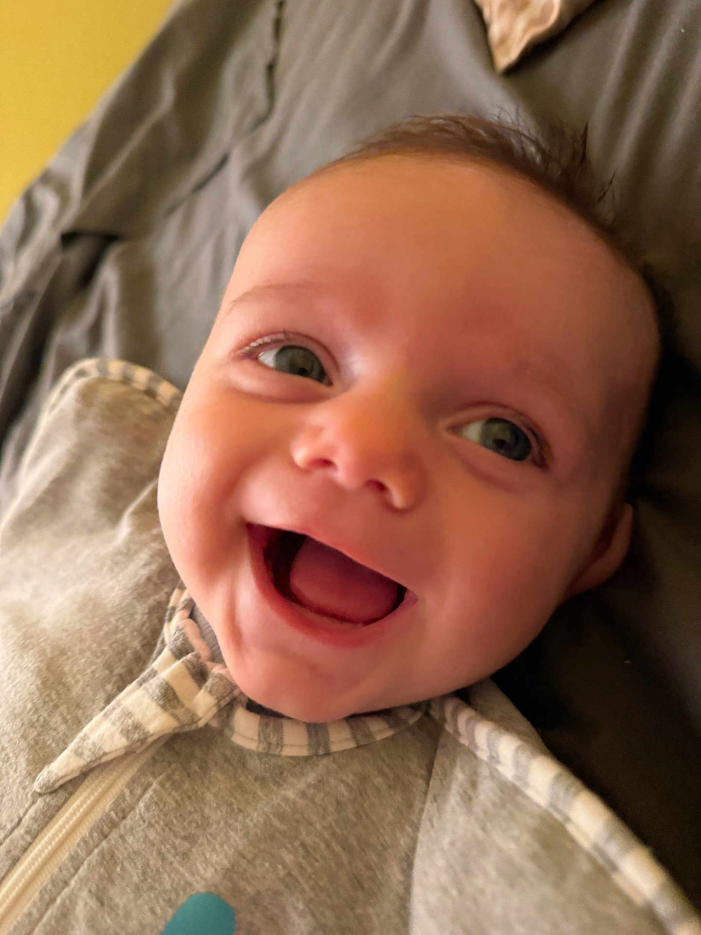 Lucas joined the competition — help win amazing prizes! baby, smiling, close_up, face, eyes, infant, happy, child, expression, cozy, clothing, grey, striped, soft, indoors, portrait, young, cute, mouth_open, lying_down