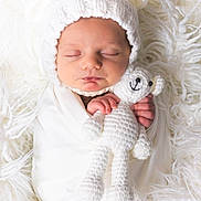 Lucas joined the competition — help win amazing prizes! newborn, baby, sleeping, white, knit_hat, teddy_bear, crocheted_toy, blanket, soft_texture, cute, infant, portrait, cozy, wrapped, child, peaceful, closeup, hands, face, adorable