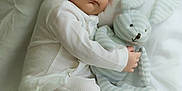 Lucas is registered to the contest to win money with this photo: baby, sleeping, pajamas, plush_toy, bunny, white_blanket, infant, cute, peaceful, soft_toy, child, bed, rest, cozy, adorable, newborn, comfort, portrait, indoor, childhood