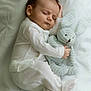 baby, sleeping, pajamas, plush_toy, bunny, white_blanket, infant, cute, peaceful, soft_toy, child, bed, rest, cozy, adorable, newborn, comfort, portrait, indoor, childhood