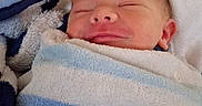 Zayne is registered to the contest to win money with this photo: baby, newborn, infant, wrapped, towel, smiling, sleeping, cozy, indoor, blanket, face, head, comfort, soft, cute, child, portrait, resting, young, peaceful