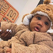 Jahyriaa is registered to the contest to win money with this photo: baby, bead_maze, bear_theme, child, closeup, cozy, curious_expression, cute, fuzzy_clothing, hand, hat, indoor, infant, manicure, person, portrait, soft_texture, wall_art, warm_clothing, wooden_toy