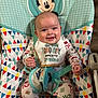 baby, smiling, bib, pajamas, mickey_mouse, baby_seat, colorful, festive, happy, child, indoors, seatbelt, holiday_theme, cute, infant, clothing, face, person, portrait, playful