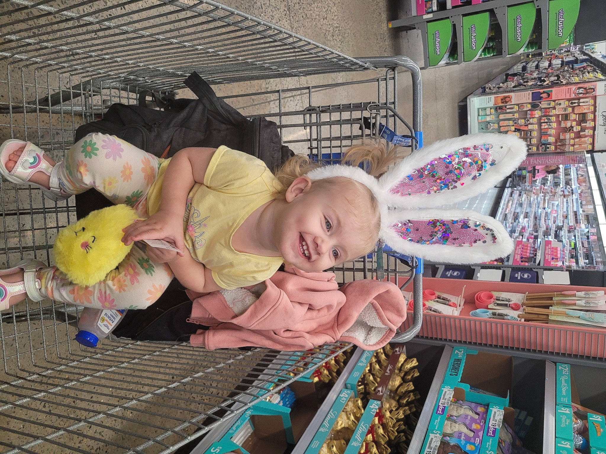 June is registered to the contest to win money with this photo: baby, baby_products, child, doll, fun, joy, leisure, market, person, public_space, retail, room, shelf, shelving, sitting, toddler, toy, vacation