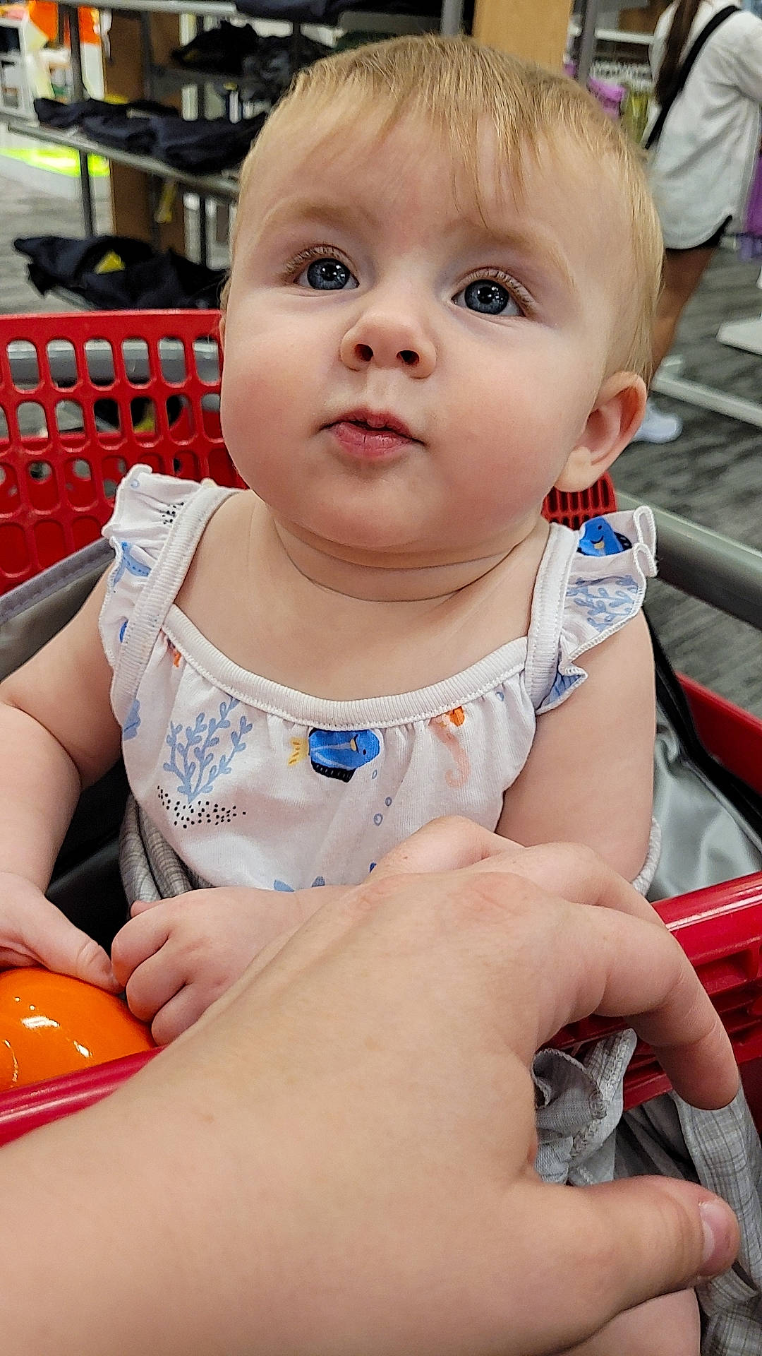 June is registered to the contest to win money with this photo: baby, baby_toddler_clothing, ball, cheek, child, eyelash, face, finger, fun, hand, happy, iris, mouth, nail, nose, person, sitting, skin, summer, thumb