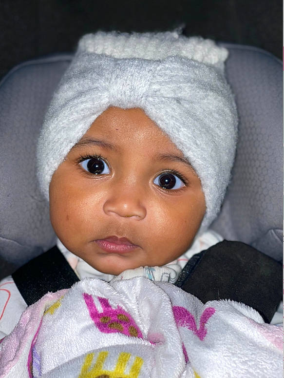 Kaelyn is registered to the contest to win money with this photo: baby, cap, cheek, chin, eye, eyebrow, eyelash, face, head, headwear, iris, jacket, lip, nose, outerwear, person, pink, skin, sleeve, smile