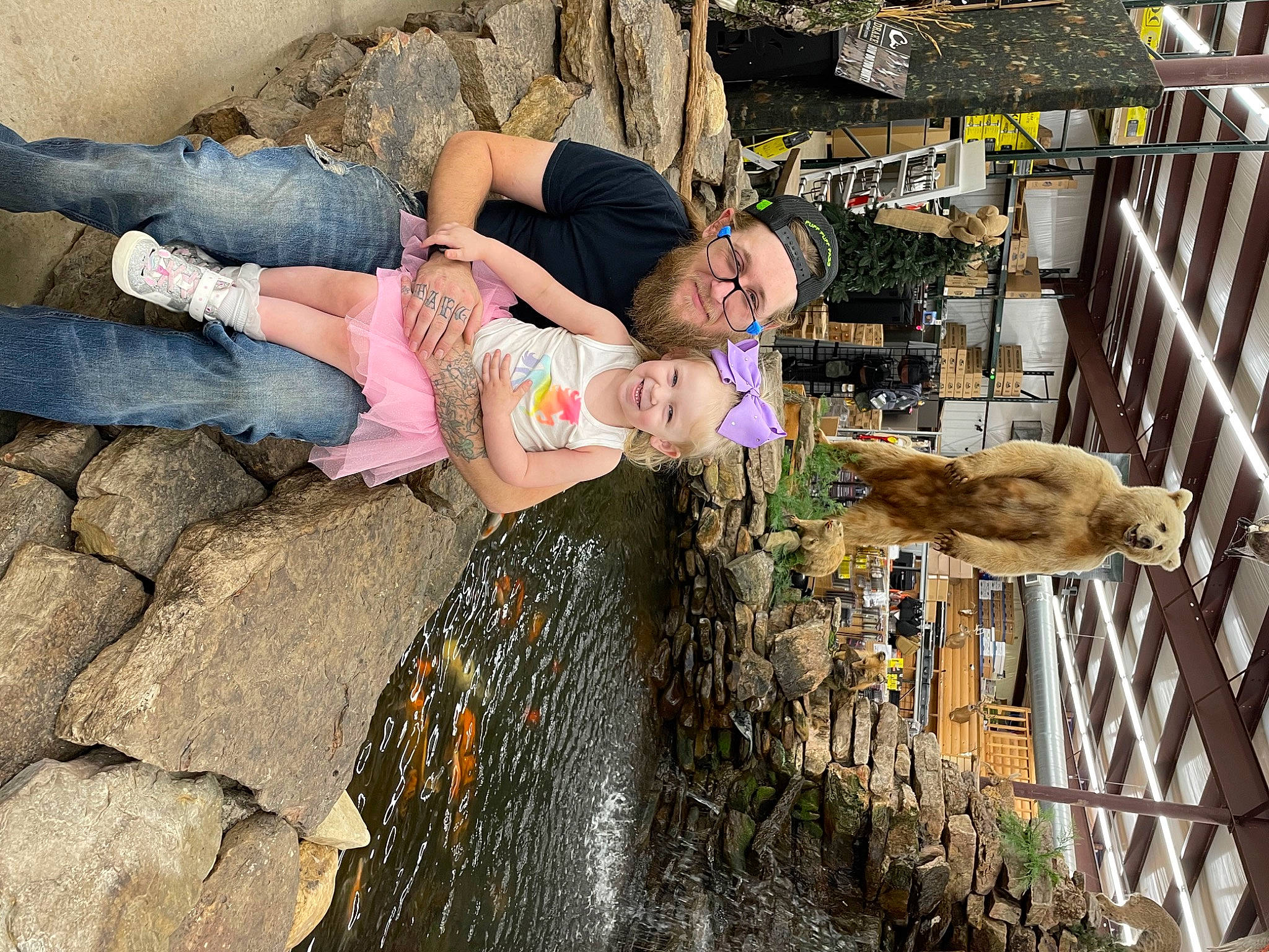 Skyler is registered to the contest to win money with this photo: clothing, fun, hat, headwear, human_leg, joy, landscape, leisure, person, rock, sandal, shorts, smile, soil, thigh, tourism, travel, tree, water_feature, wood