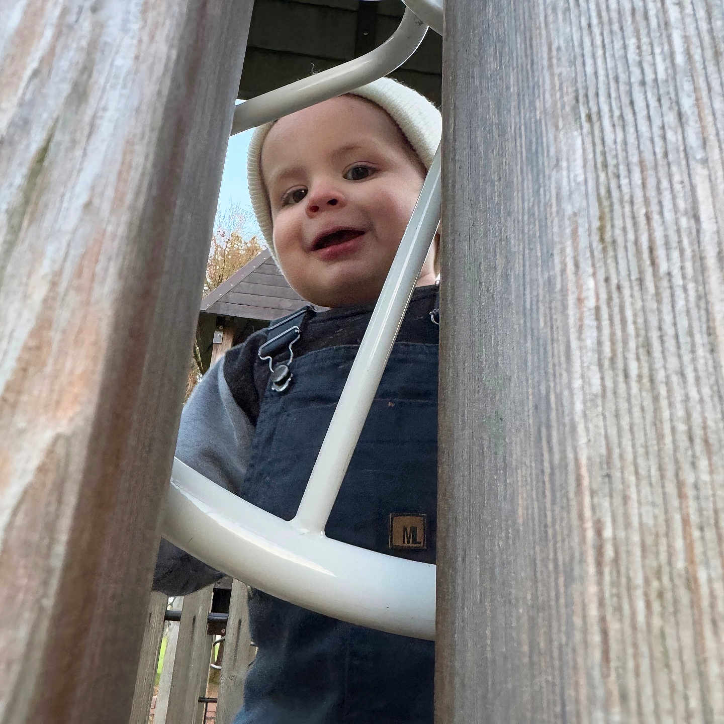 Alec is registered to the contest to win money with this photo: baby, clothing, coat, face, grass, head, indoors, interiordesign, jacket, nature, outdoorplayarea, outdoors, pants, park, person, photography, plant, playarea, portrait, wood
