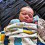 newborn, baby, sleeping, blanket, mittens, bed, quilt, cozy, infant, peaceful, cute, face, resting, soft, wrapped, child, lying_down, indoors, comfort, portrait