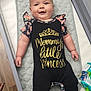 baby, infant, crib, clothing, floral, black_outfit, padded_mat, smiling, child, cute, person, indoor, nursery, happy, lying_down, footwear, wooden_floor, diapers, baby_wipes, family