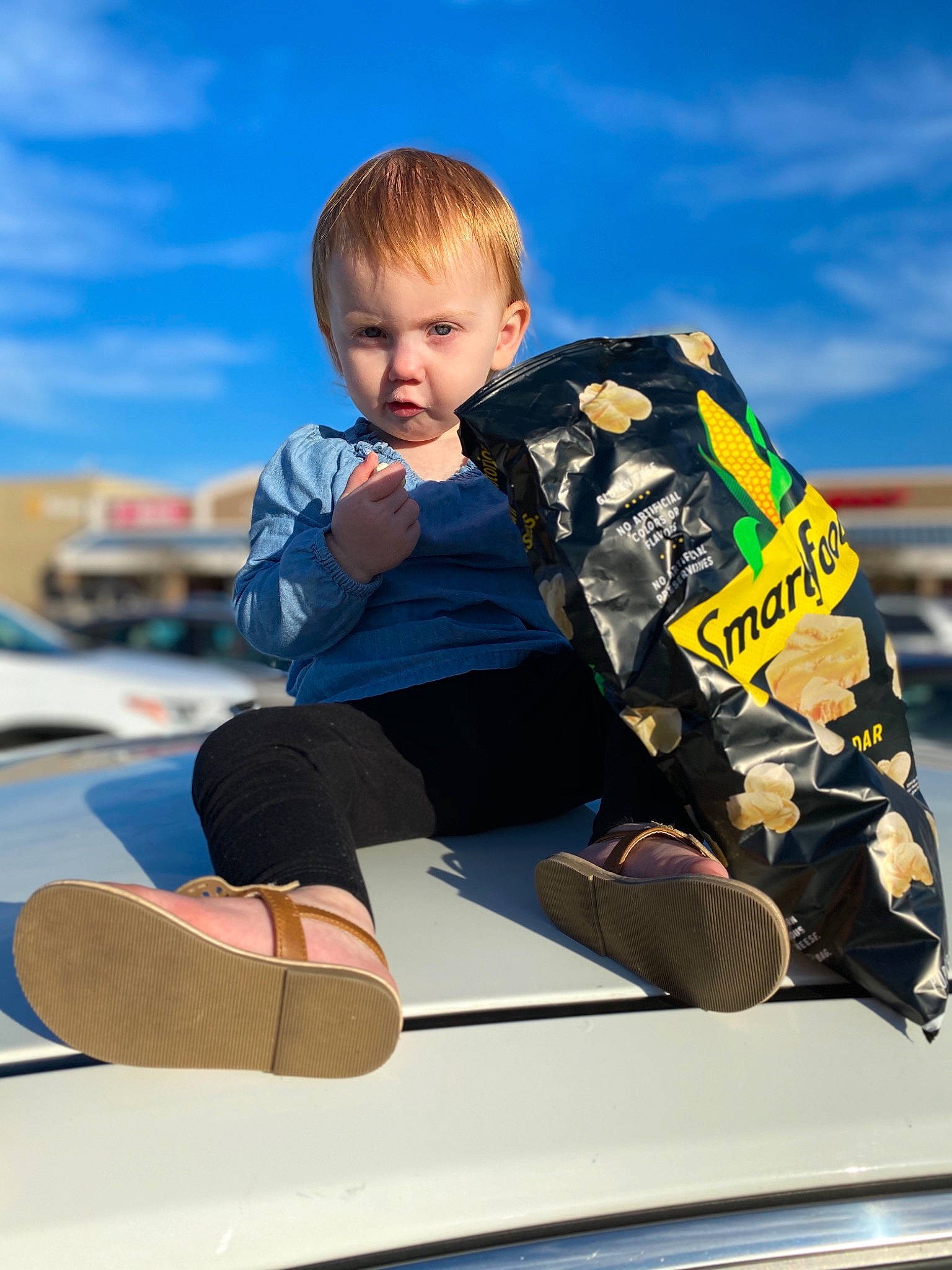 Maelee joined the competition — help win amazing prizes! automotive_design, automotive_exterior, blue, bumper, cloud, electric_blue, fun, hood, leisure, motor_vehicle, person, personal_protective_equipment, recreation, shorts, sitting, sky, sleeve, t_shirt, toddler, travel