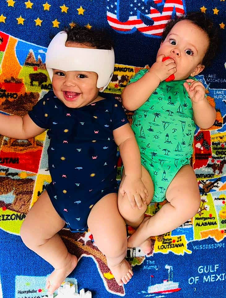 Tobias is registered to the contest to win money with this photo: baby, baby_toddler_clothing, blue, child, facial_expression, finger, fun, happy, head, headwear, human_body, human_leg, joy, leg, pattern, person, red, smile, snapshot, thigh